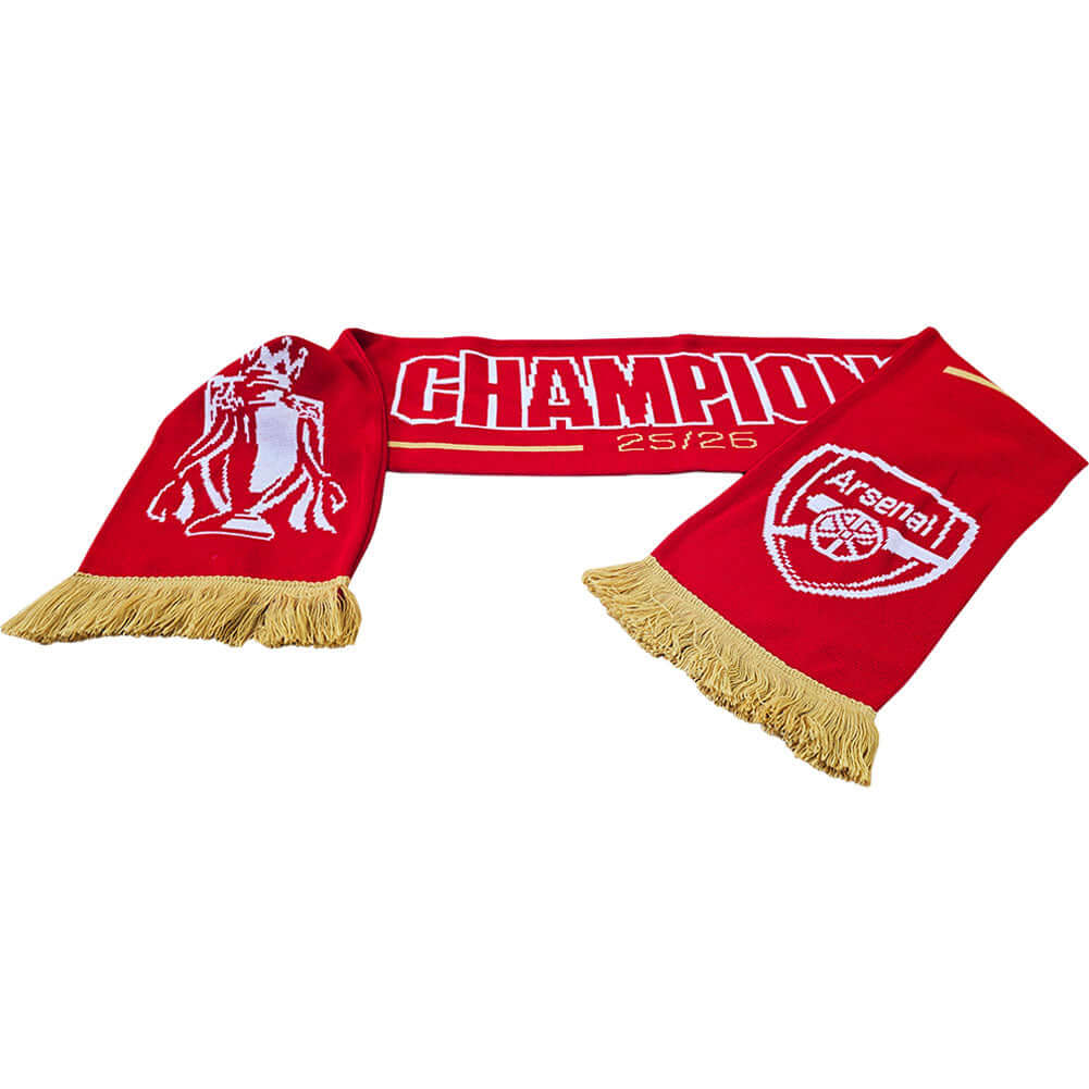 Arsenal FC Gold Premier League Champions Scarf LKT Sport Red and white jacquard knit scarf with gold fringeWith Champions 25/26 text in white and goldBoth sides feature a large Arsenal club crest and Premier League trophy at each endOfficial licensed prod