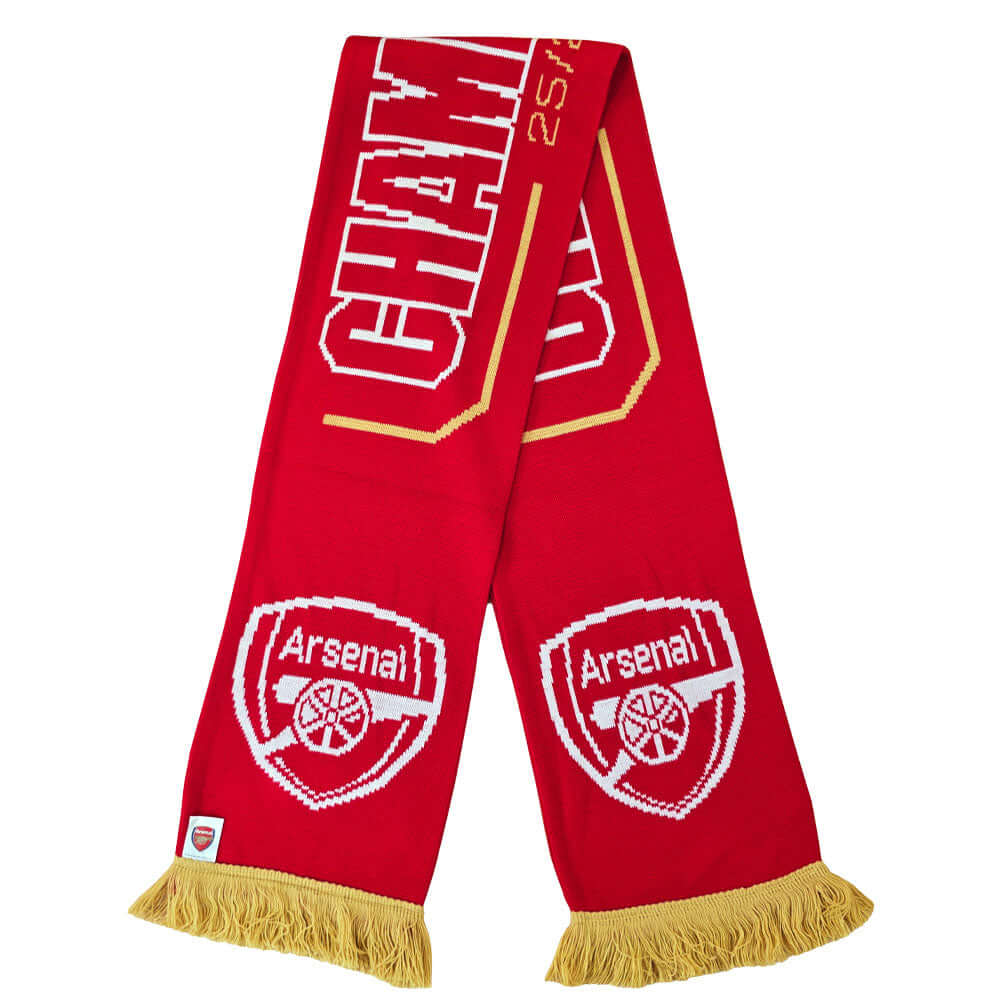 Arsenal FC Gold Premier League Champions Scarf LKT Sport Red and white jacquard knit scarf with gold fringeWith Champions 25/26 text in white and goldBoth sides feature a large Arsenal club crest and Premier League trophy at each endOfficial licensed prod