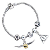 Harry Potter Silver Plated Spellbeads Bracelet LKT Sport Harry Potter Deathly Hallows and Golden Snitch charms on a silver plated charm bracelet with three spellbeadsThis bracelet includes 3 spacer beads with spells engraved around themFrom a collection o