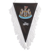 Newcastle United FC Triangular Mini Pennant LKT Sport Satin look triangular design mini pennantFeaturing a full colour NUFC crest with Est 1892 textFinished with white tassels and hanging stringIdeal for your car or windowOfficial licensed productApprox 1