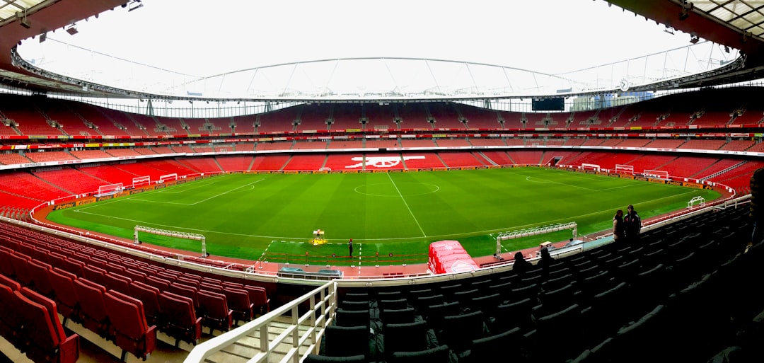 Iconic football stadiums English Premier League, featuring the Emirates Stadium's vibrant interior and lush green pitch.