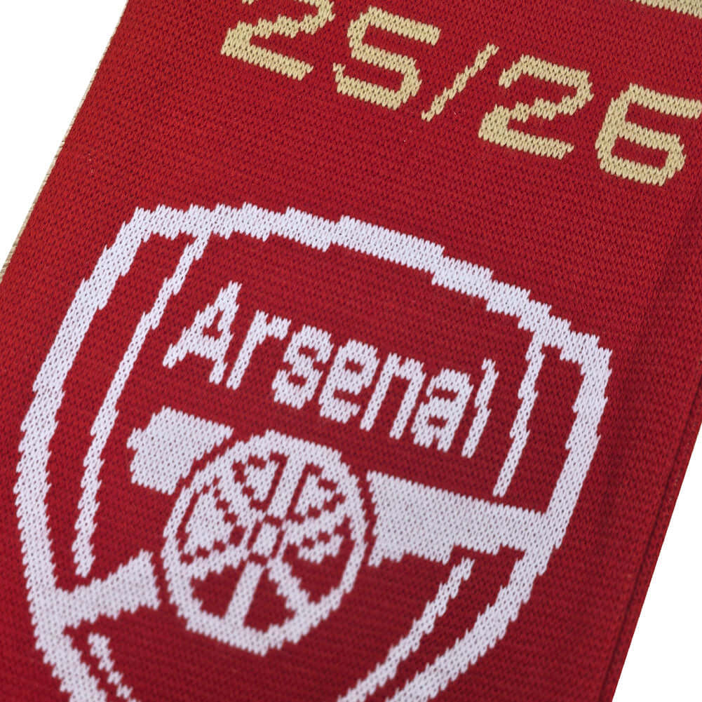 Arsenal FC Champions Scarf LKT Sport Red and white jacquard knit scarf with white fringeWith Champions 25/26Both sides feature a large Arsenal club crest at each endOfficial licensed productApprox 132cm x 19cm Scarves