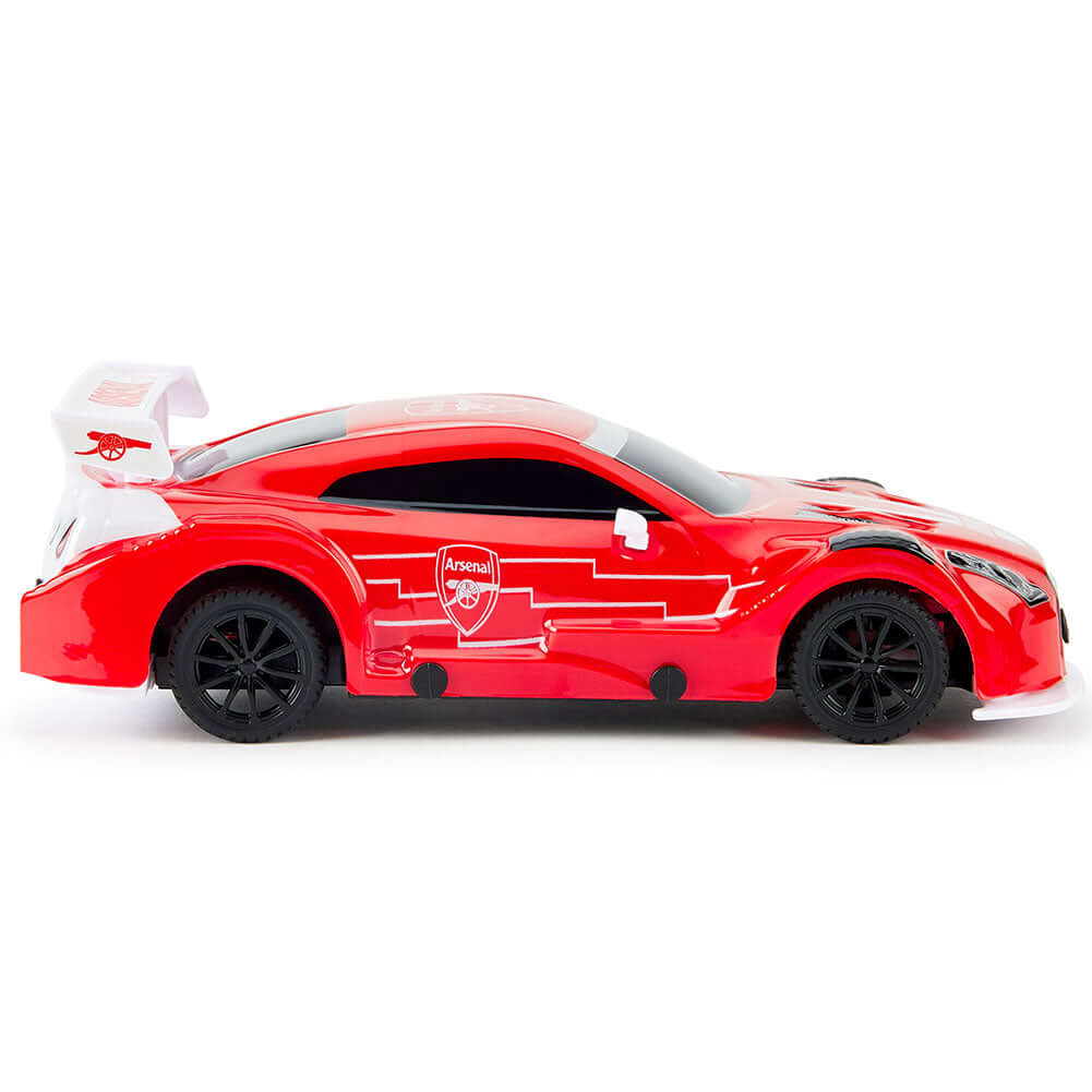 Arsenal FC Radio Control Sportscar 1:24 Scale LKT Sport Sleek and streamlined sportscar with iconic style brandingComplete with Arsenal FC crests on the roof and doorsIncludes an oversized spoiler on the rear for stability and speedWorking spring suspensi