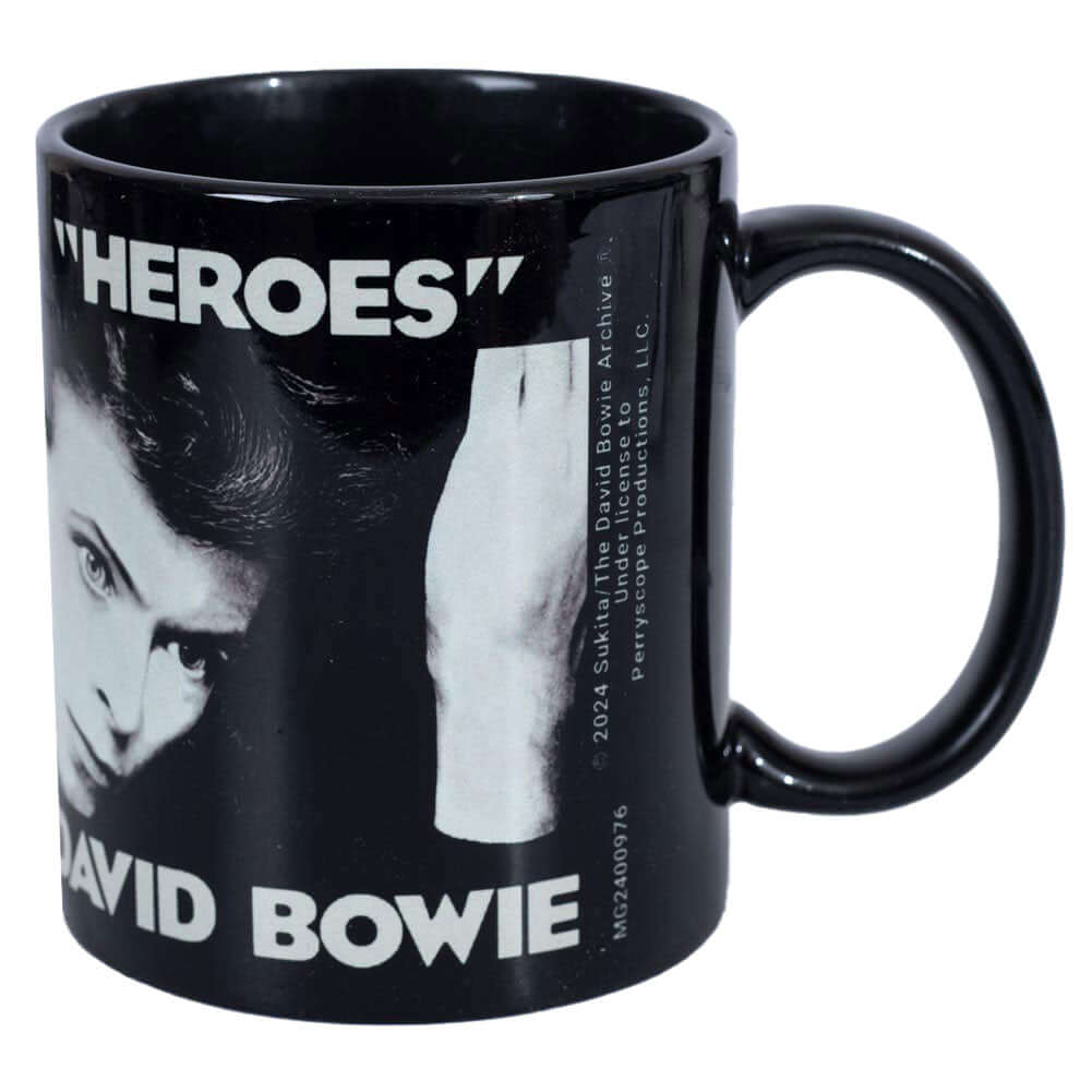 David Bowie Heroes Mug LKT Sport Ceramic everyday coffee mugFeatures the iconic 'Heroes' album coverGlazed kiln fired finish with black handleOfficial Licensed MerchandiseApprox 315ml (11oz)Approx 9cm tall, 8cm in diameter Mugs
