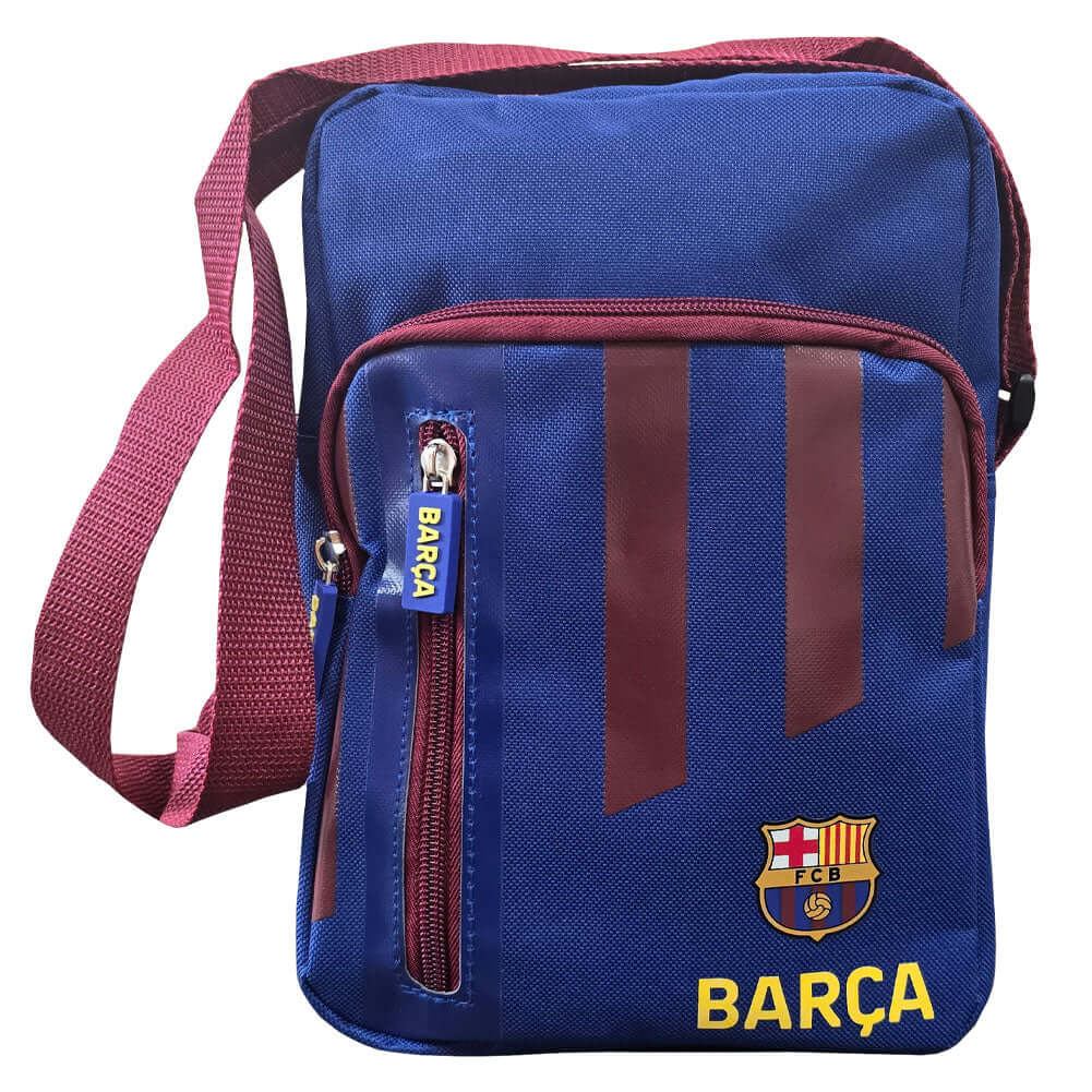 FC Barcelona Stripe Shoulder Bag LKT Sport Stripe design shoulder bag featuring Barca text and club crestMain compartment has a large double zipped opening for easy access2 front zip pockets and interior open pocketAdjustable shoulder strapRubber zip pull