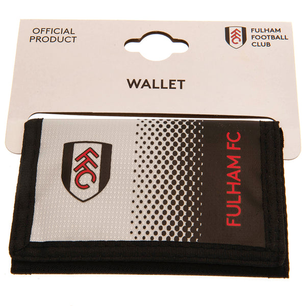 Fulham FC Fade Wallet LKT Sport Fade design wallet featuring Fulham text and club crest5 separate internal compartmentsExternal zipped pocketWipe clean polyesterOfficial licensed productApprox 12cm x 8cm closed Wallets
