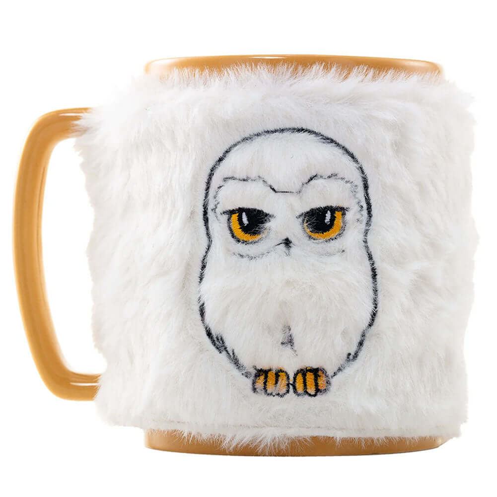Harry Potter Fuzzy Hedwig Mug LKT Sport Enjoy your drink with a touch of magic... this mug combines a unique design along with a removable fluffy cover for added comfortThis mustard yellow mug includes images of Hedwig with smaller Hogwarts themed images