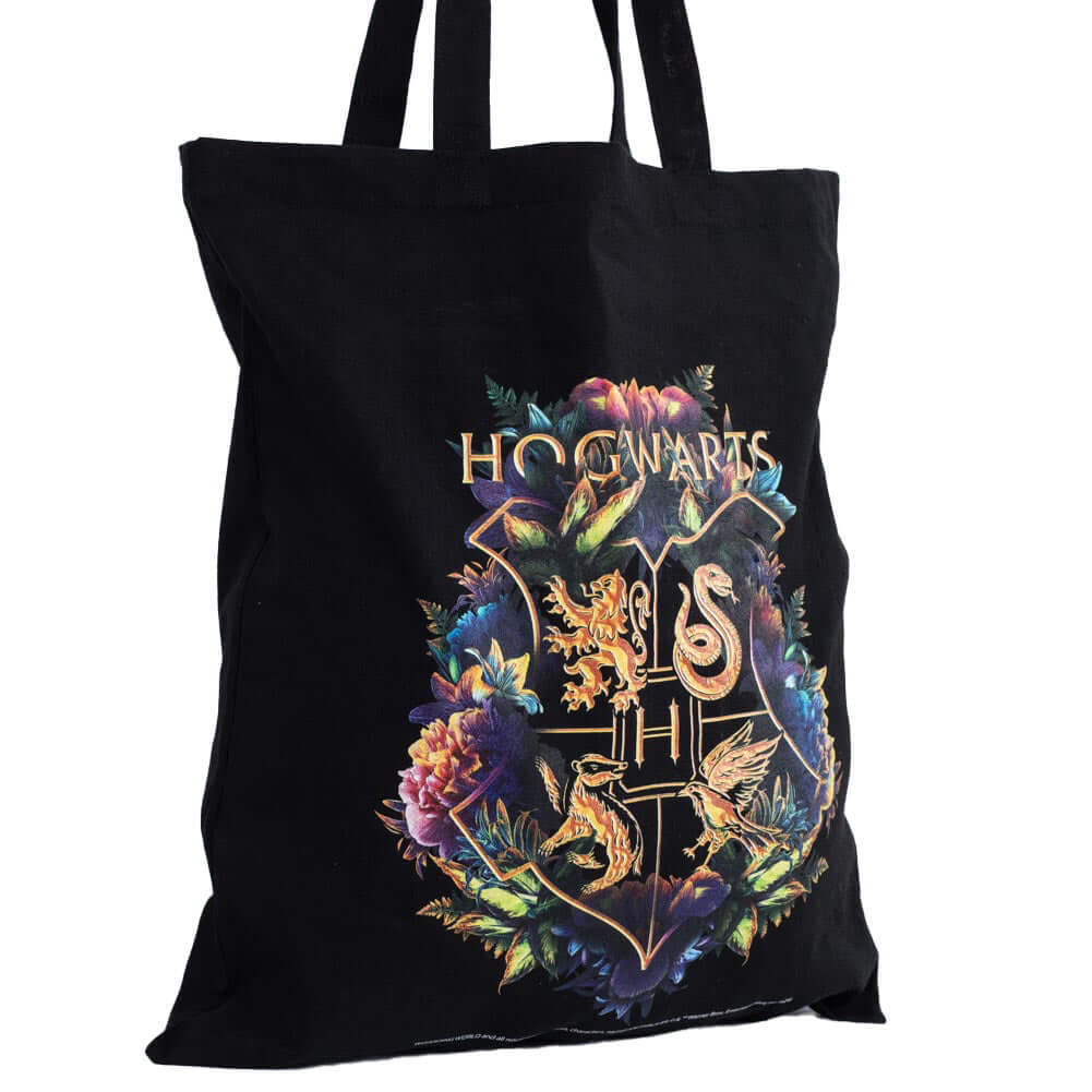 Harry Potter Hogwarts Crest Canvas Tote Bag LKT Sport Black canvas tote bag featuring a large gold printed Hogwarts crest surrounded by colourful flowersMade from 100% Cotton canvas materialOfficial licensed productApprox 41cm x 37cm Tote Bags