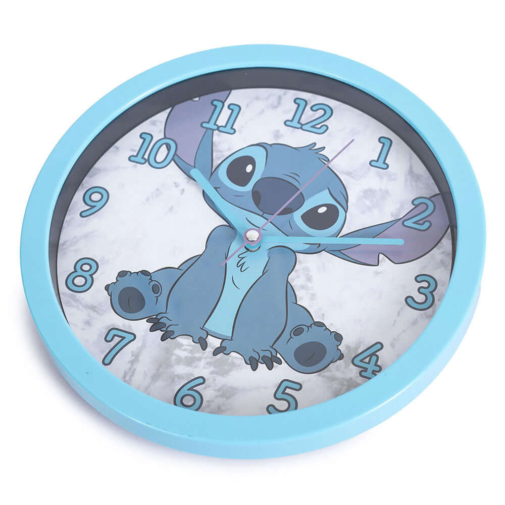 Lilo & Stitch Wall Clock LKT Sport Sky blue hanging wall clock featuring Stitch on the faceDurable plastic case with a clear font and modern quartz movementRequires x1 AA Battery (not included)Official licensed productApprox 25cm in diameter Wall Clocks