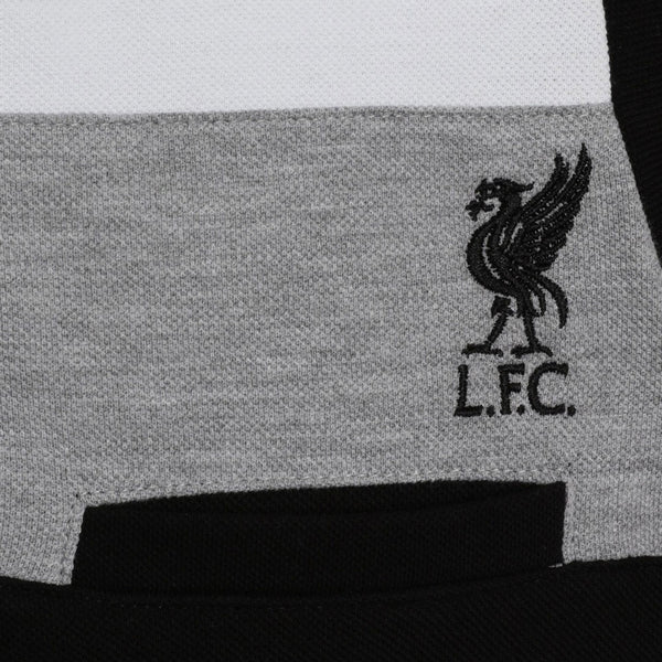 Liverpool FC Colour Block Polo Junior 7-8 Yrs LKT Sport Junior black block design polo with grey and white panellingFeatures the Liverbird crest in black embroideryWith red LFC hem tab detail100% Cotton machine washableOfficial licensed productJunior 7-8