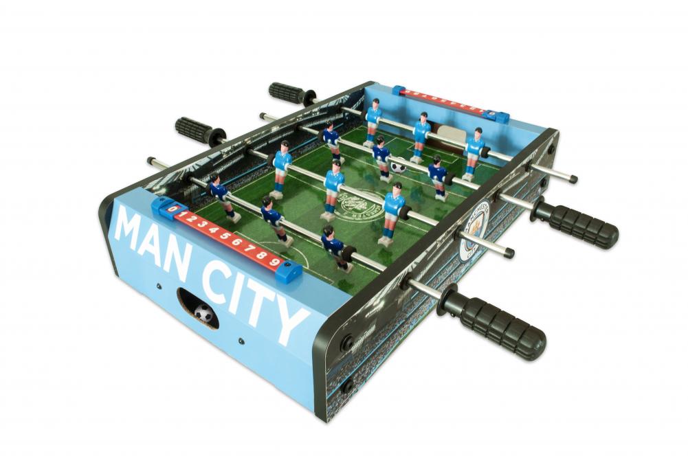 Manchester City FC 20 inch Football Table Game LKT Sport Table top, football game in a stadium and pitch design 6 players per team in sky or royal blue Sturdy construction with grass effect printed pitch A score indicator on each side Complete with two pl