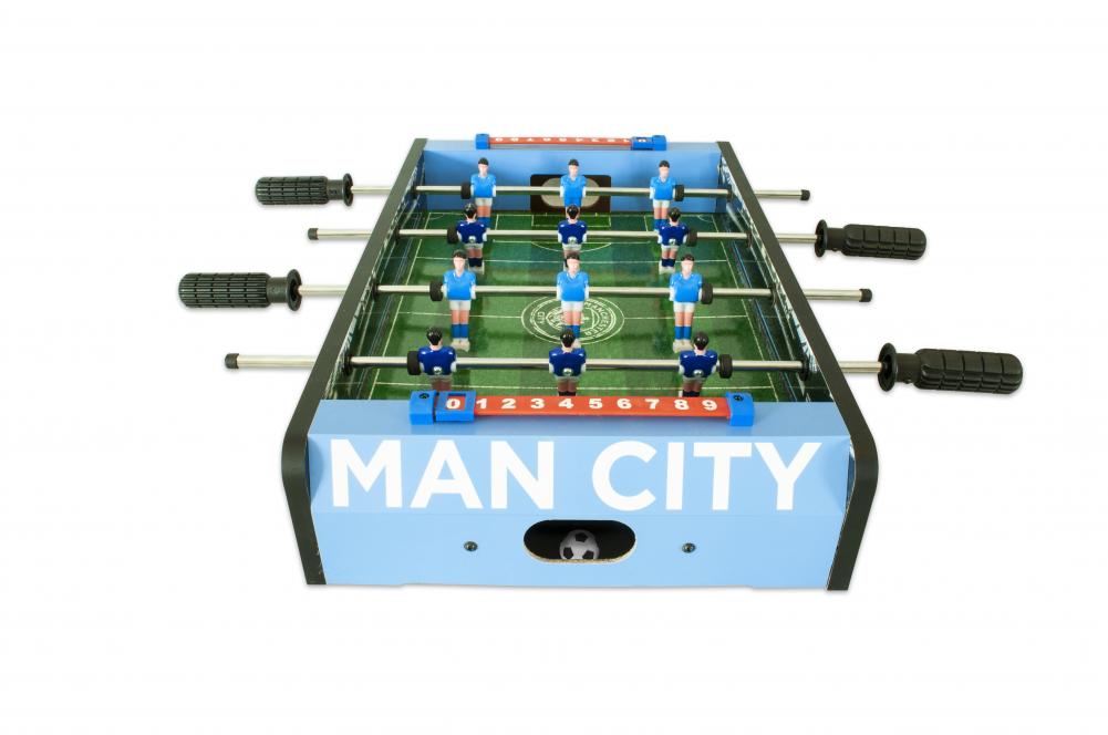 Manchester City FC 20 inch Football Table Game LKT Sport Table top, football game in a stadium and pitch design 6 players per team in sky or royal blue Sturdy construction with grass effect printed pitch A score indicator on each side Complete with two pl