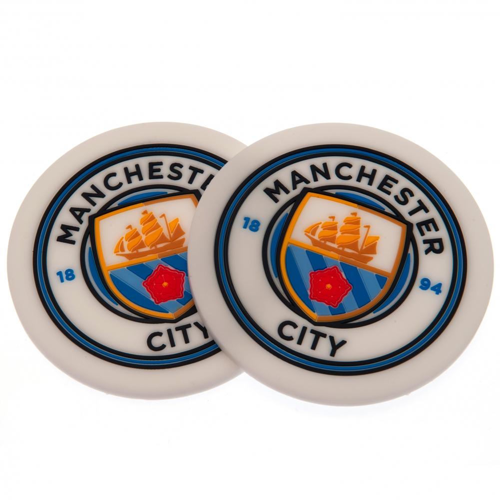 Manchester City FC 2pk Coaster Set LKT Sport Pack of 2 flexible non slip silicone coasters Vibrant colour coasters each with a stamped City crest Wipe clean finish Official licensed product Approx 10cm in diameter On a header card Coasters