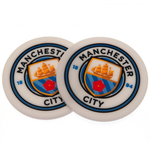 Manchester City FC 2pk Coaster Set LKT Sport Pack of 2 flexible non slip silicone coasters Vibrant colour coasters each with a stamped City crest Wipe clean finish Official licensed product Approx 10cm in diameter On a header card Coasters