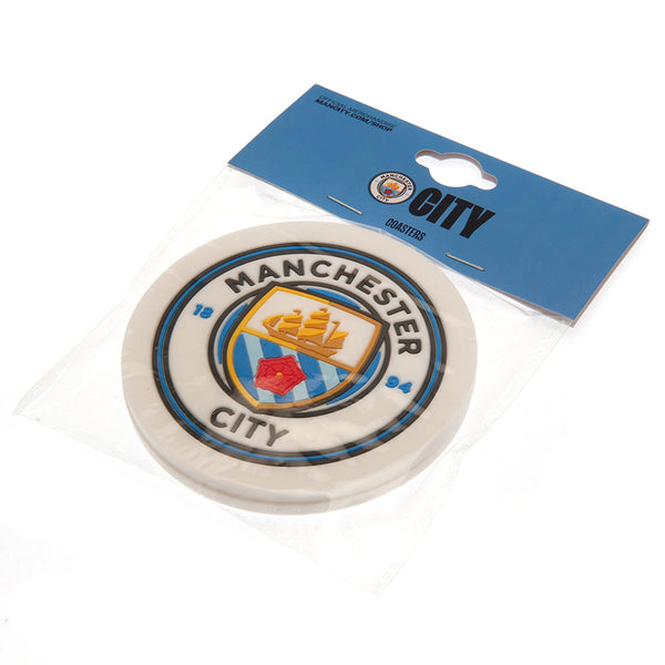 Manchester City FC 2pk Coaster Set LKT Sport Pack of 2 flexible non slip silicone coasters Vibrant colour coasters each with a stamped City crest Wipe clean finish Official licensed product Approx 10cm in diameter On a header card Coasters