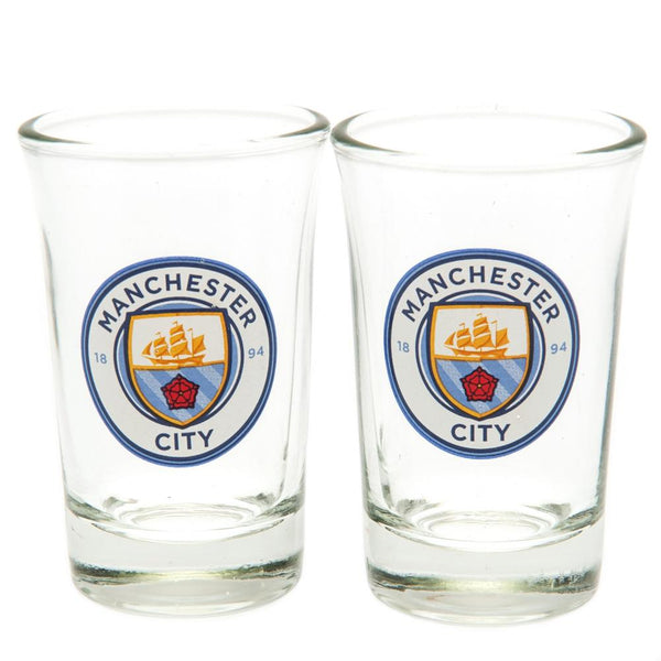 Manchester City FC 2pk Shot Glass Set LKT Sport Set of 2 shot glasses Featuring full colour Manchester City FC club crest Official licensed product Approx 50ml (2oz) Approx 7cm tall, 4cm in diameter In a display packet Shot Glasses