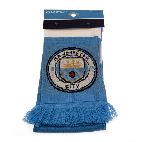 Manchester City FC Bar Scarf LKT Sport Sky blue and white bar stripe design jacquard knit scarf with sky blue fringe Both sides feature a large full colour Man City club crest at each end Official licensed product Approx 132cm x 19cm On a header card Scar