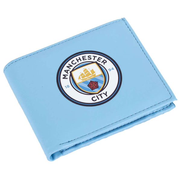 Manchester City FC Coloured PU Wallet LKT Sport Blue PU wallet featuring a large printed club crest3 card slots, a window slot and 2 note pocketsChange pocket with secure stud fastener2 additional compartmentsOfficial licensed productApprox 11cm x 9cm Wal