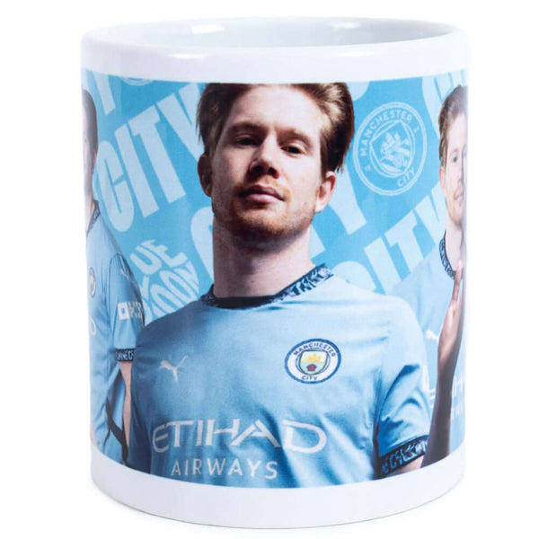 Manchester City FC De Bruyne Mug LKT Sport Ceramic everyday coffee mugBlue and white mug featuring images of Kevin De Bruyne with a City crest and textGlazed kiln fired finish with white handleOfficial licensed productApprox 315ml (11oz)Approx 9cm tall, 8