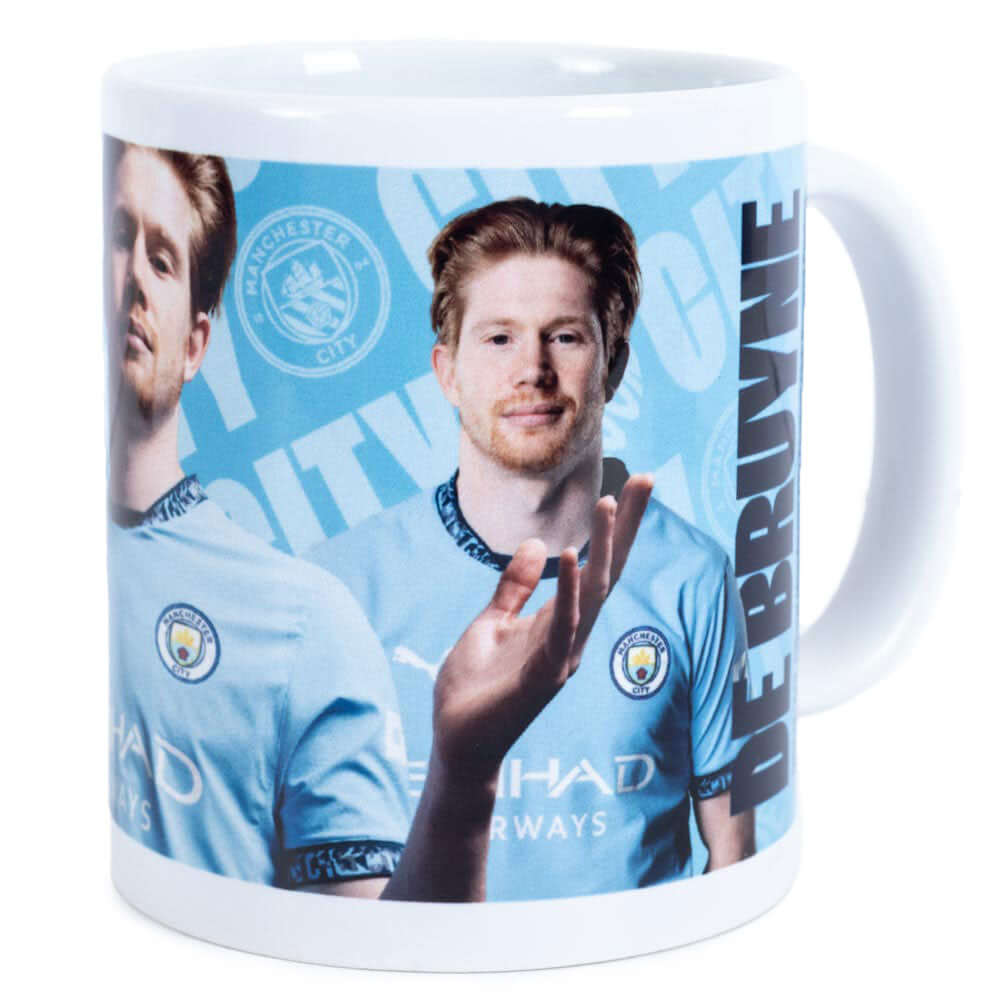 Manchester City FC De Bruyne Mug LKT Sport Ceramic everyday coffee mugBlue and white mug featuring images of Kevin De Bruyne with a City crest and textGlazed kiln fired finish with white handleOfficial licensed productApprox 315ml (11oz)Approx 9cm tall, 8