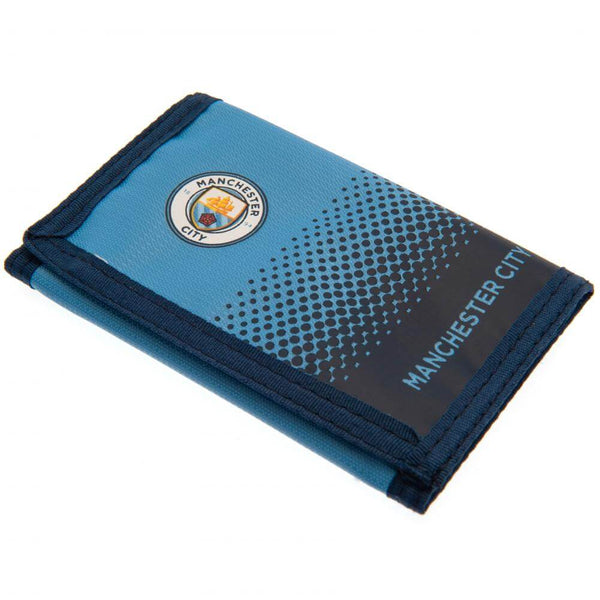 Manchester City FC Fade Wallet LKT Sport Fade design wallet featuring Man City text and full colour club crest5 separate internal compartmentsExternal zipped pocketWipe clean polyesterOfficial licensed productApprox 12cm x 8cm closed Wallets