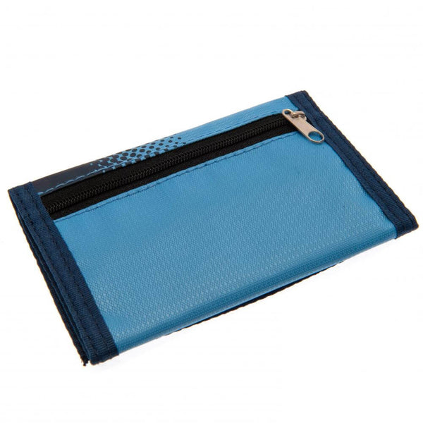 Manchester City FC Fade Wallet LKT Sport Fade design wallet featuring Man City text and full colour club crest5 separate internal compartmentsExternal zipped pocketWipe clean polyesterOfficial licensed productApprox 12cm x 8cm closed Wallets