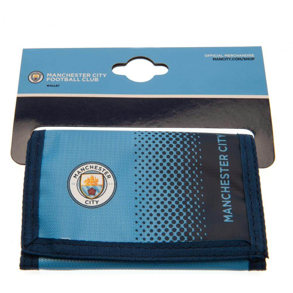 Manchester City FC Fade Wallet LKT Sport Fade design wallet featuring Man City text and full colour club crest5 separate internal compartmentsExternal zipped pocketWipe clean polyesterOfficial licensed productApprox 12cm x 8cm closed Wallets