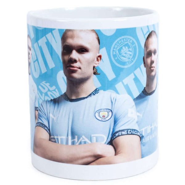 Manchester City FC Haaland Mug LKT Sport Ceramic everyday coffee mugBlue and white mug featuring images of Erling Haaland with a City crest and textGlazed kiln fired finish with white handleOfficial licensed productApprox 315ml (11oz)Approx 9cm tall, 8cm