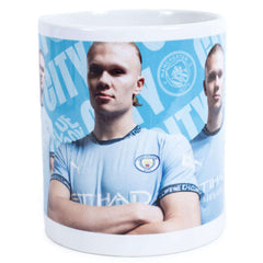 Manchester City FC Haaland Mug LKT Sport Ceramic everyday coffee mugBlue and white mug featuring images of Erling Haaland with a City crest and textGlazed kiln fired finish with white handleOfficial licensed productApprox 315ml (11oz)Approx 9cm tall, 8cm