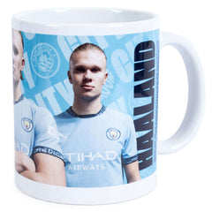 Manchester City FC Haaland Mug LKT Sport Ceramic everyday coffee mugBlue and white mug featuring images of Erling Haaland with a City crest and textGlazed kiln fired finish with white handleOfficial licensed productApprox 315ml (11oz)Approx 9cm tall, 8cm