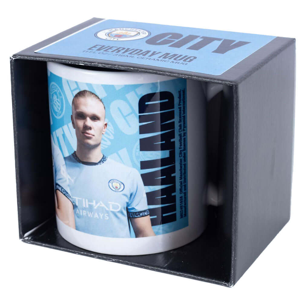 Manchester City FC Haaland Mug LKT Sport Ceramic everyday coffee mugBlue and white mug featuring images of Erling Haaland with a City crest and textGlazed kiln fired finish with white handleOfficial licensed productApprox 315ml (11oz)Approx 9cm tall, 8cm