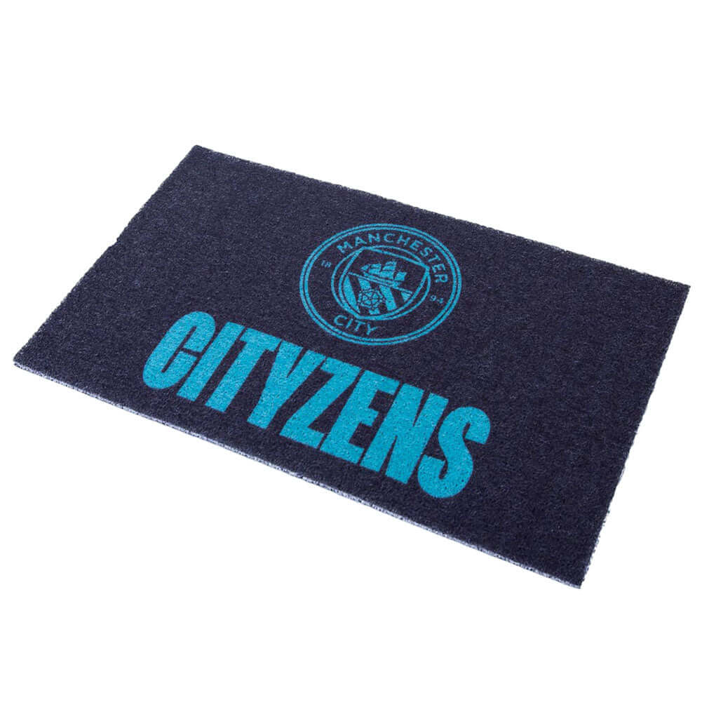 Manchester City FC Loop Pile Doormat LKT Sport White heavy duty printed PVC doormatFeatures a blue City crest and Cityzens textIdeal for both indoors and outdoorsOfficial licensed productApprox 75cm x 45cm Door Mats Hauptbild