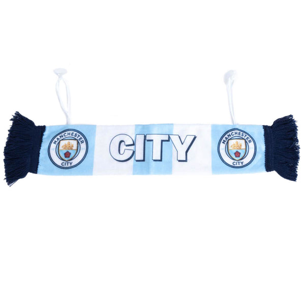 Manchester City FC Mini Car Bar Scarf LKT Sport Mini cloth scarf finished with blue tassels at either endFeaturing two club crests and CITY textComes with suction pads ready for hanging at home or in your carOfficial licensed productApprox 46cm x 9cm Spor
