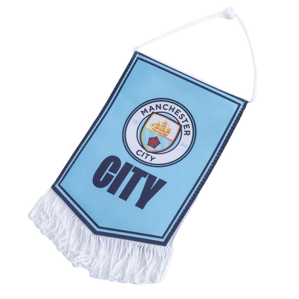 Manchester City FC Mini Pennant LKT Sport Satin look crest design pennantFeaturing a full colour Man City crest with the text CITY underneath on a sky blue backgroundFinished with white tassels and hanging stringIdeal for your car or windowOfficial licens