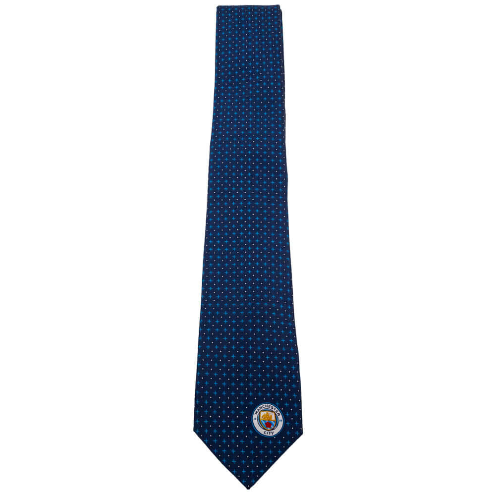 Manchester City FC Navy Blue Tie LKT Sport Navy blue patterned tie featuring a small City crest to the bottomIncludes an embroidered crest on the reverse100% polyesterOfficial licensed productApprox 148cm x 8cm Neckties