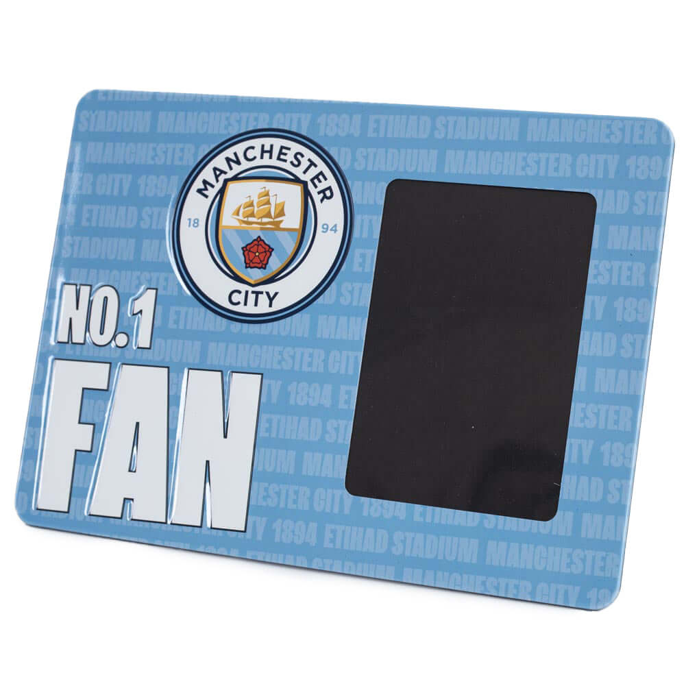 Manchester City FC No1 Fan Picture Frame Sign LKT Sport Sturdy metal photo frame sign featuring the Man City crest and NO.1 FAN in bold white textIncludes the text 'Manchester City 1894 Etihad Stadium' as a repeat pattern in the backgroundWith a portrait Main image