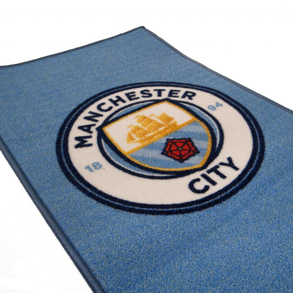 Manchester City FC Rug LKT Sport Bright colourful bedroom rug featuring a large central club crest Made from 100% polyamide with a non-slip backing Machine washable Official licensed product Approx 80cm x 50cm On a header card Rugs