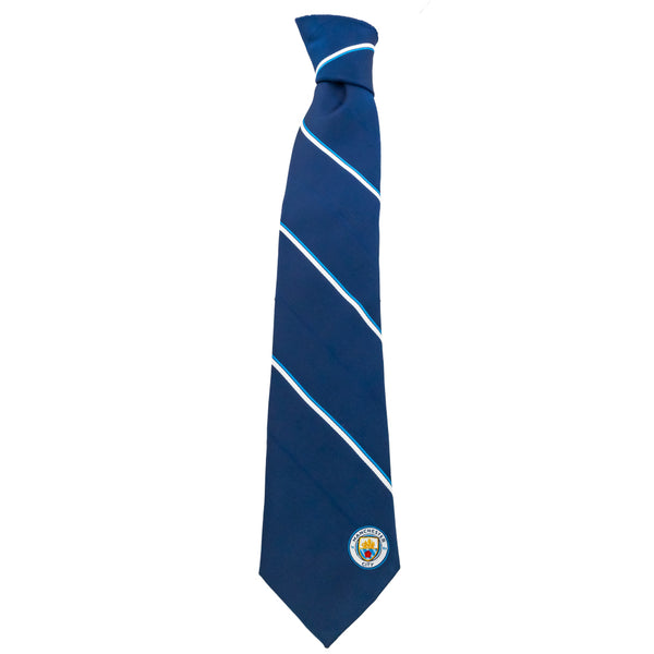 Manchester City FC Stripe Tie LKT Sport Navy blue and white striped tie featuring a small City crest to the bottomIncludes an embroidered crest on the reverse100% polyesterOfficial licensed productApprox 148cm x 8cm Neckties