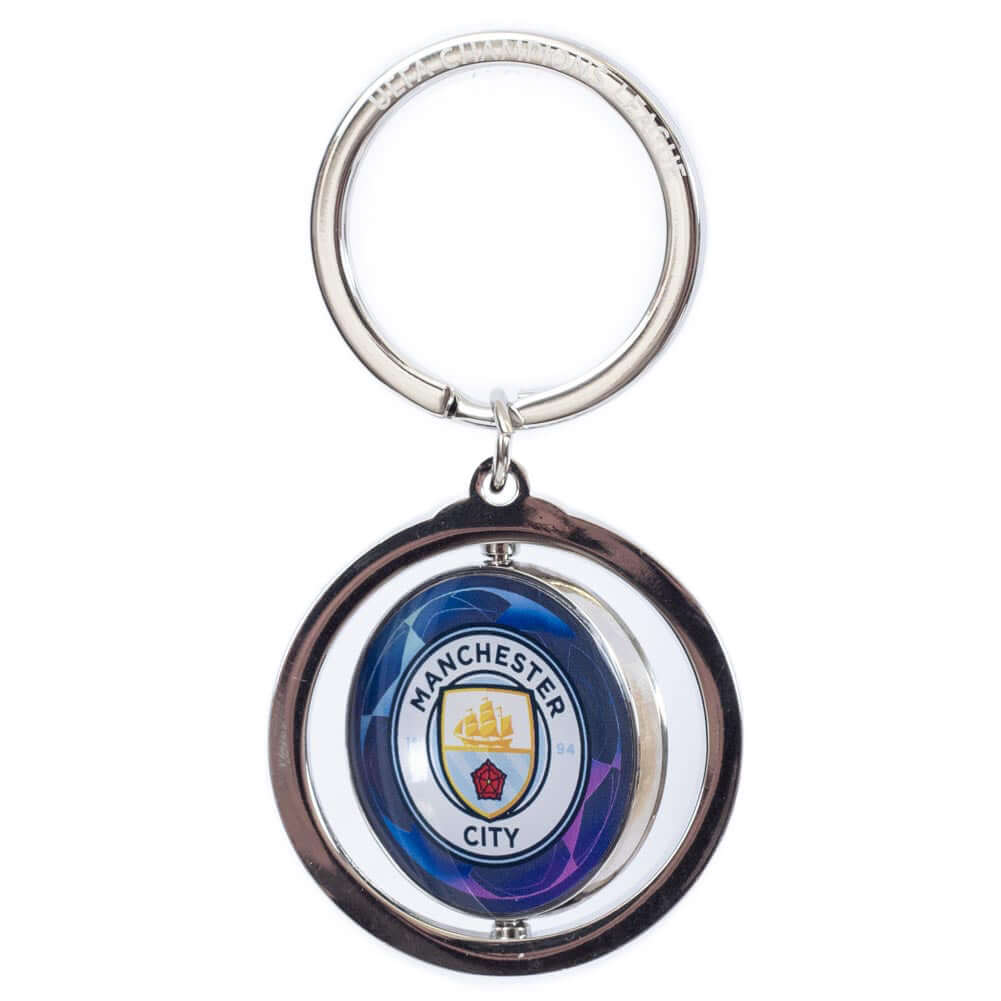 Manchester City FC UCL Spinner Keyring LKT Sport Metal spinner keyring with a split ring attachedFeatures a spinning Man City logo, with a UEFA champions league logo on the reverseMetal alloy with silver finishOfficial licensed productApprox 35mm x 35mm K Main image