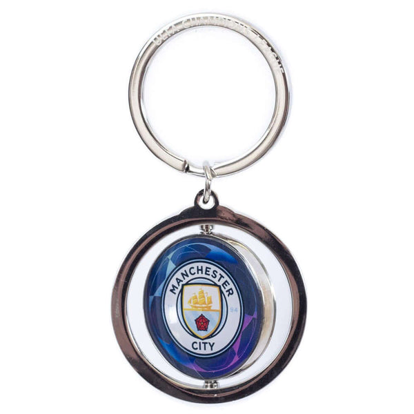 Manchester City FC UCL Spinner Keyring LKT Sport Metal spinner keyring with a split ring attachedFeatures a spinning Man City logo, with a UEFA champions league logo on the reverseMetal alloy with silver finishOfficial licensed productApprox 35mm x 35mm K