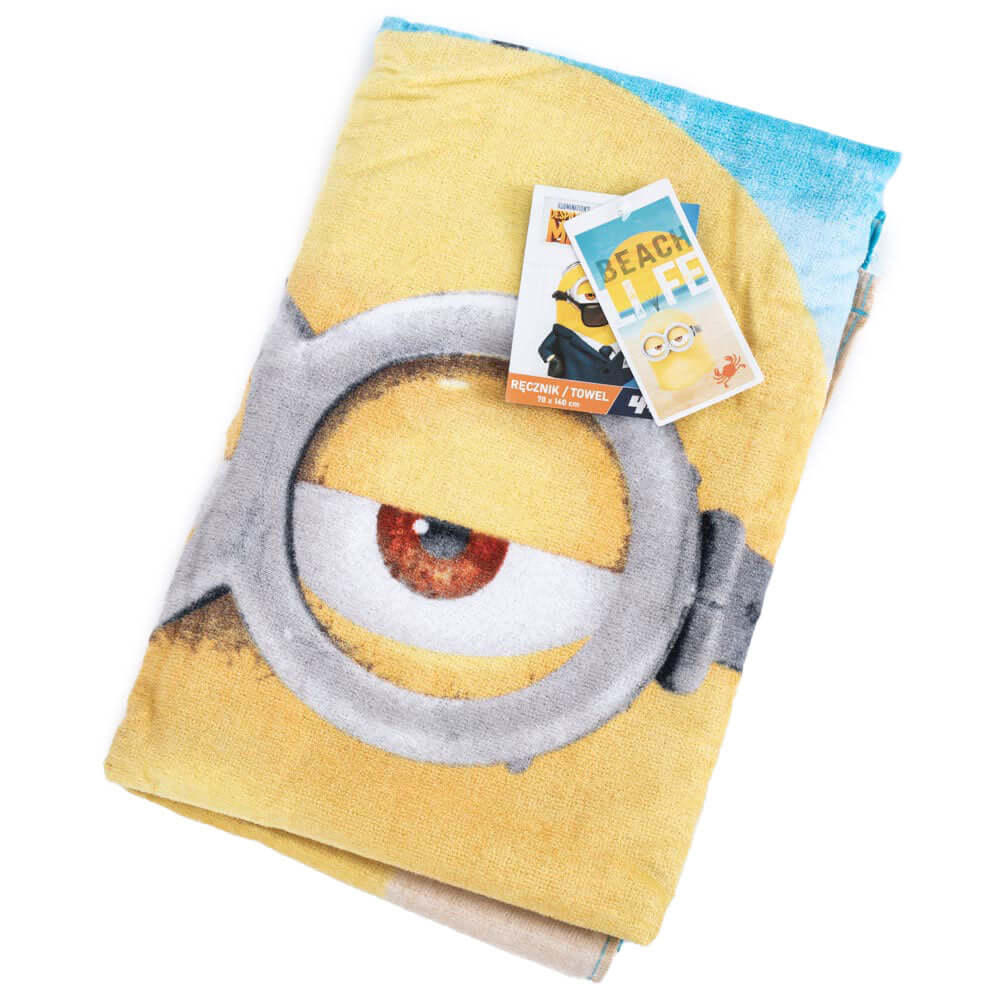 Minions Towel LKT Sport Large soft to touch velour beach towelBeach themed towel featuring the text 'Beach Life' with one of the Minions submerged in sandVibrant 100% cotton towelOfficial licensed productApprox 140cm x 70cm Beach Towels