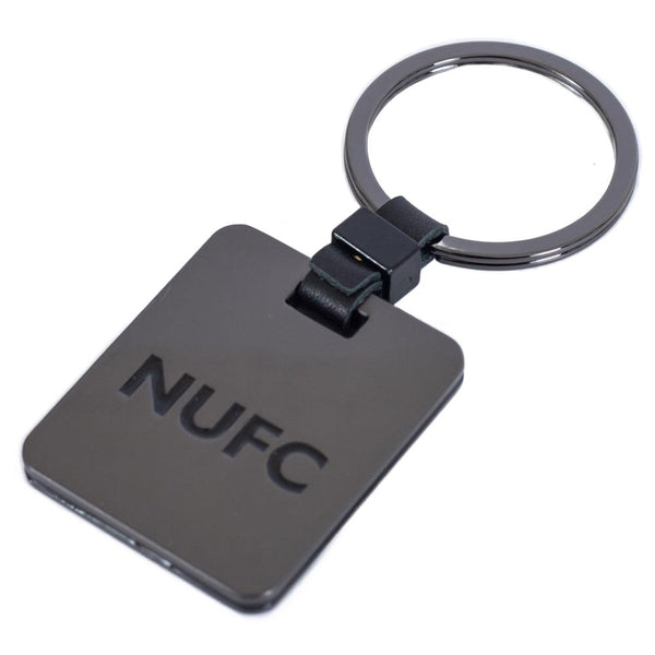 Newcastle United FC Galvanised Keyring LKT Sport Brushed gunmetal finish with a black leather link attachment and split ringfeatures the NUFC crest in a subtle greyOfficial licensed productApprox 35mm x 40mm Keychains
