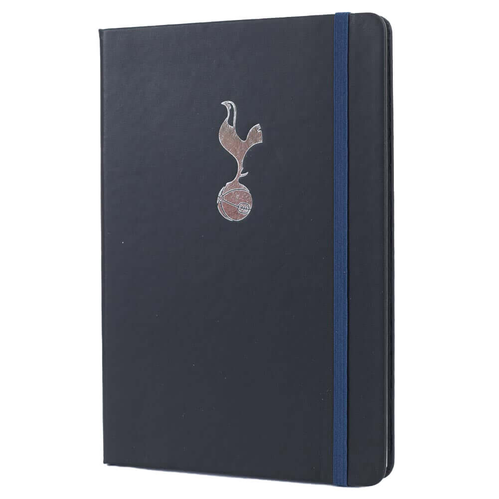 Tottenham Hotspur FC Classic Notebook LKT Sport Premium black faux leather hardback notebook with a silver embossed Tottenham CrestRuled pages featuring a Tottenham crest and a handy bookmarkComplete with an elastic closureOfficial licensed productApprox