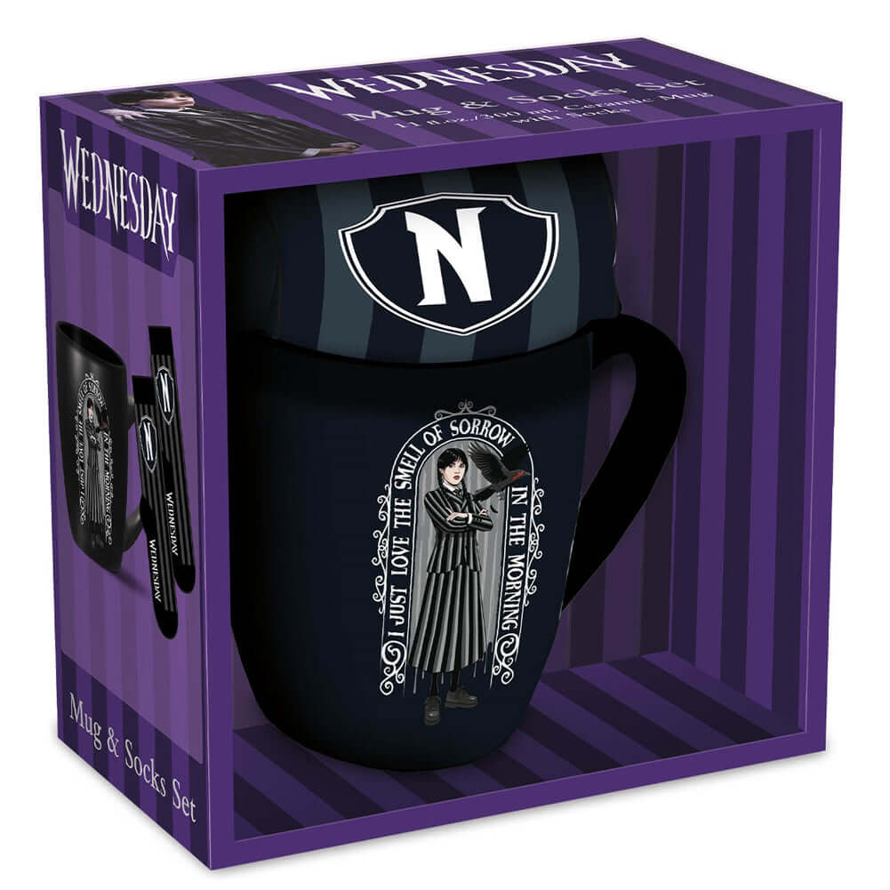 Wednesday Mug & Sock Set LKT Sport Classic mug and sock gift setEmbrace your dark side with every sip, this set is perfect for fans who want to enjoy their coffee with a gothic twistBlack mug and socks set featuring Wednesday Addams adn the text 'I just l Main image
