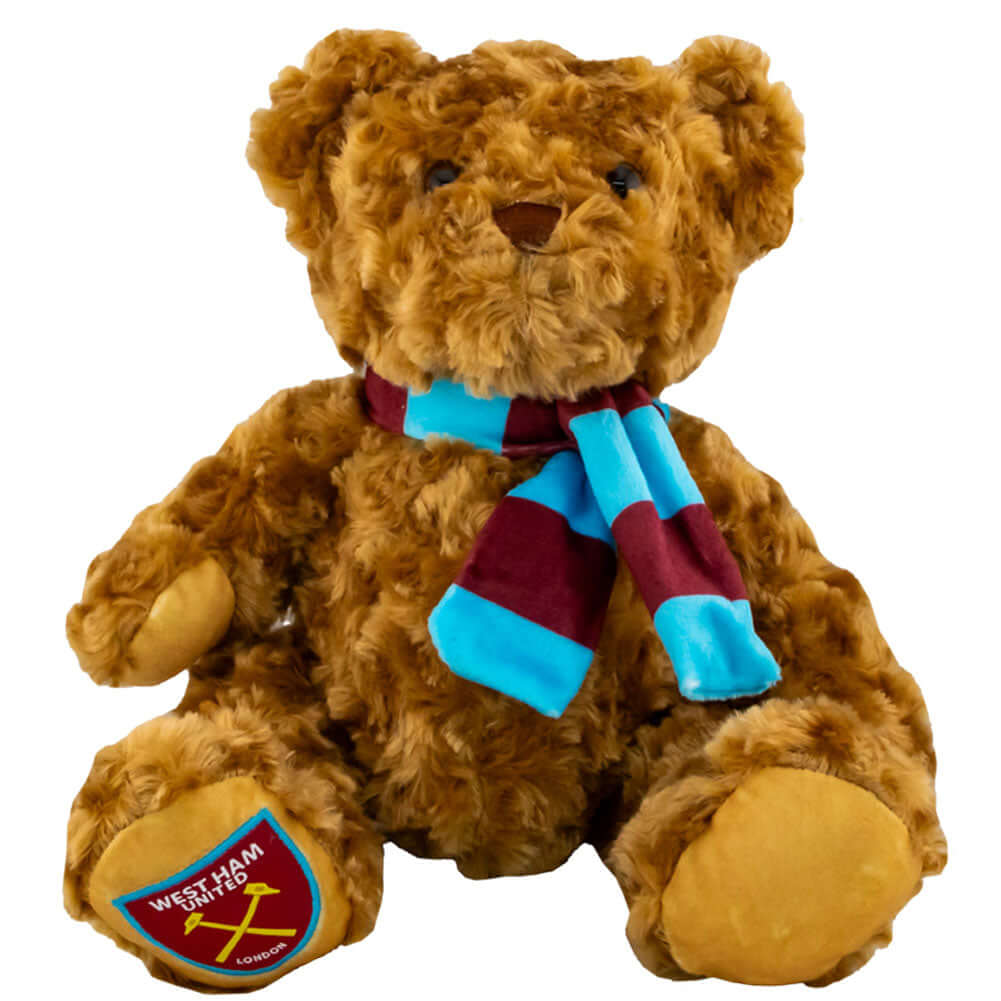 West Ham United FC Supersoft Classic Bear LKT Sport Super soft classic bear in sitting position with beaded eyesWearing a vibrant blue and claret scarf with a West Ham crest on the bears paw100% polyesterOfficial licensed productApprox 23cm in sitting pos