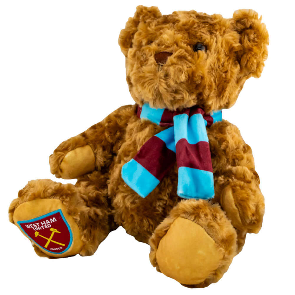 West Ham United FC Supersoft Classic Bear LKT Sport Super soft classic bear in sitting position with beaded eyesWearing a vibrant blue and claret scarf with a West Ham crest on the bears paw100% polyesterOfficial licensed productApprox 23cm in sitting pos