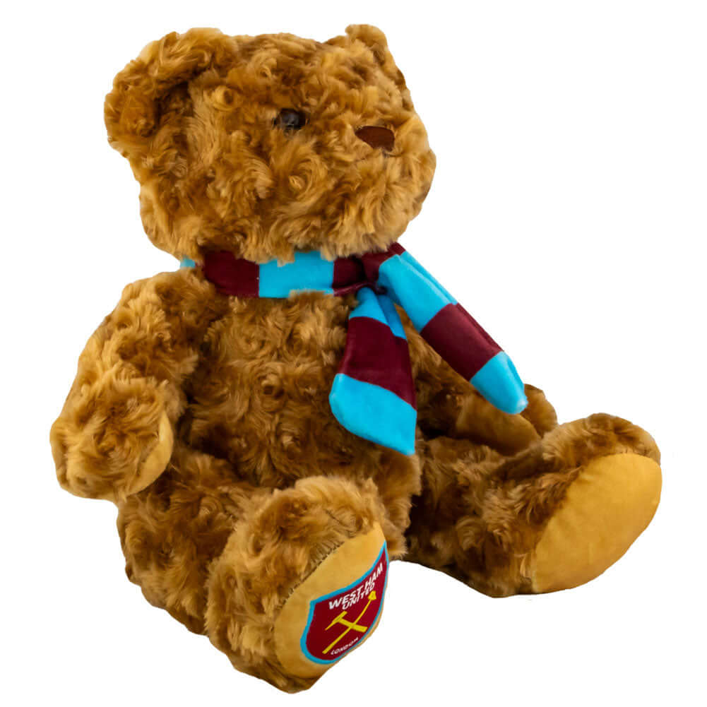 West Ham United FC Supersoft Classic Bear LKT Sport Super soft classic bear in sitting position with beaded eyesWearing a vibrant blue and claret scarf with a West Ham crest on the bears paw100% polyesterOfficial licensed productApprox 23cm in sitting pos